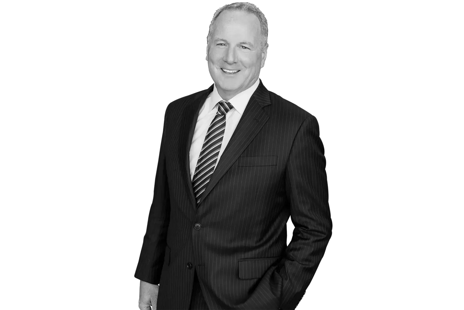 Smiling man in a dark pinstripe suit and striped tie with one hand in his pocket.